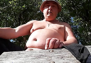 Chubby guy jerking over a bench